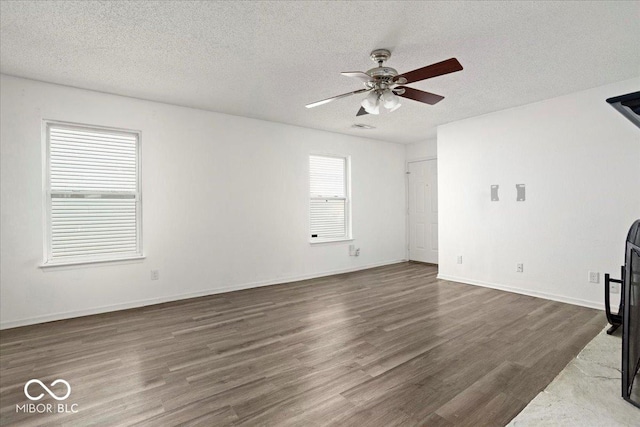 11821 Wapiti Way, Noblesville, IN 46060 - unfurnished living room featuring a ceiling fan, dark wood finished floors, a textured ceiling, and baseboards