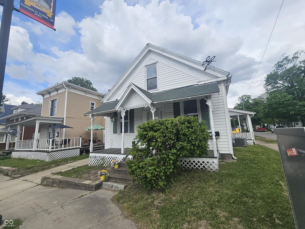 418 S Washington St, Crawfordsville, IN 47933 - view of front facade with covered porch, a front lawn, and central AC unit