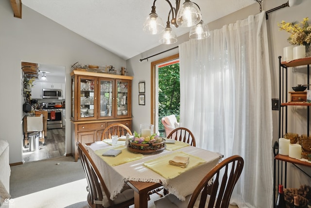1712 S Flatrock River Rd, Rushville, IN 46173 - dining space with vaulted ceiling, carpet flooring, and a chandelier