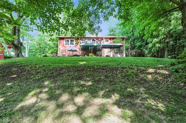 1712 S Flatrock River Rd, Rushville, IN 46173 - rear view of property with brick siding, a lawn, and a deck
