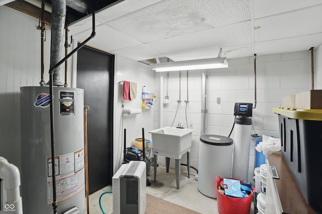 1712 S Flatrock River Rd, Rushville, IN 46173 - unfinished below grade area featuring water heater, a water softener, a sink, and a drop ceiling