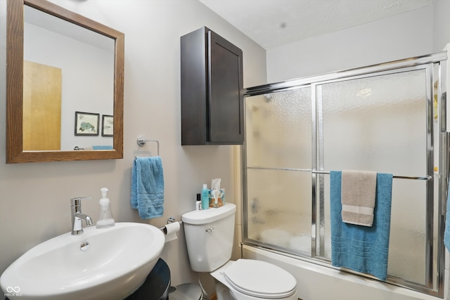 1712 S Flatrock River Rd, Rushville, IN 46173 - bathroom with a sink, bath / shower combo with glass door, and toilet