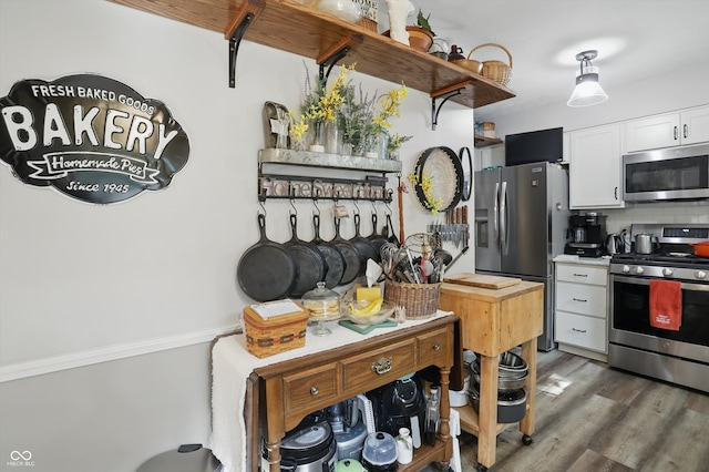 1712 S Flatrock River Rd, Rushville, IN 46173 - kitchen with appliances with stainless steel finishes, white cabinetry, tasteful backsplash, wood finished floors, and open shelves
