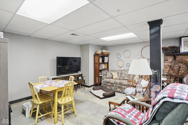 1712 S Flatrock River Rd, Rushville, IN 46173 - living area with a drop ceiling, a wood stove, and concrete floors