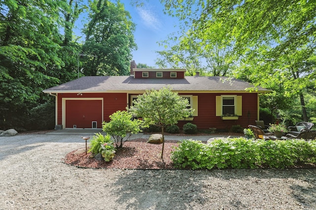 1712 S Flatrock River Rd, Rushville, IN 46173 - view of front of house featuring a garage, a chimney, and gravel driveway