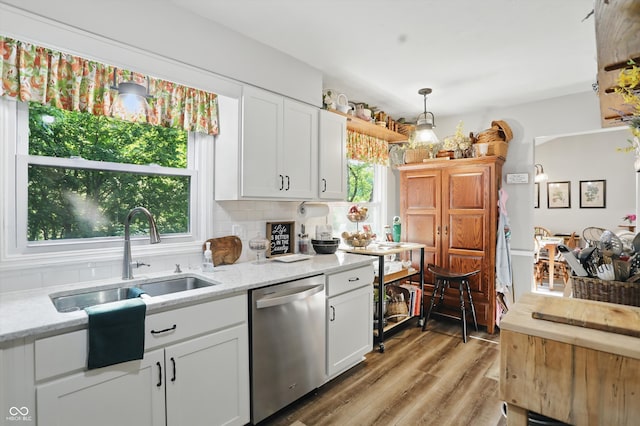 1712 S Flatrock River Rd, Rushville, IN 46173 - kitchen featuring stainless steel dishwasher, light wood-style flooring, white cabinets, a sink, and light stone counters