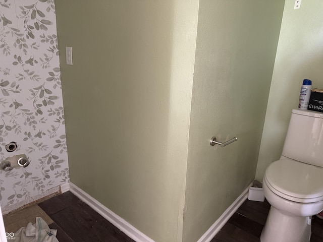 bathroom featuring baseboards, toilet, and wood finished floors