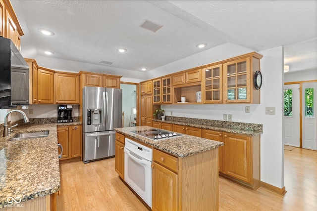 3479 Sugar Loaf Ct, Carmel, IN 46033 - kitchen featuring stainless steel fridge with ice dispenser, white oven, a kitchen island, light wood-type flooring, and recessed lighting