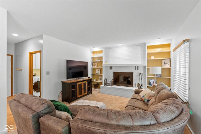 3479 Sugar Loaf Ct, Carmel, IN 46033 - living room with washer / dryer, built in shelves, a brick fireplace, and recessed lighting