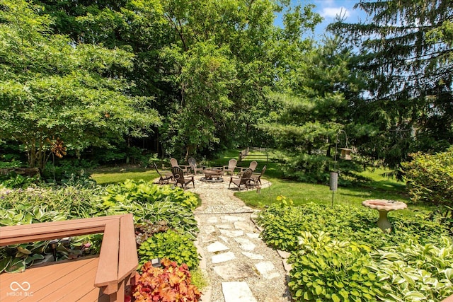 3479 Sugar Loaf Ct, Carmel, IN 46033 - view of grassy yard with an outdoor fire pit and a wooden deck