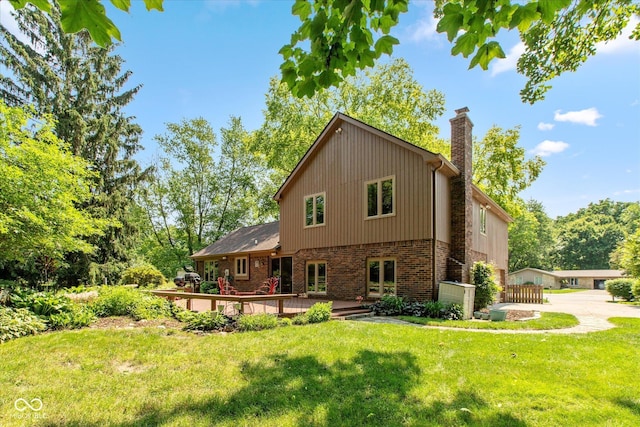 3479 Sugar Loaf Ct, Carmel, IN 46033 - rear view of property with a chimney, brick siding, a wooden deck, and a lawn