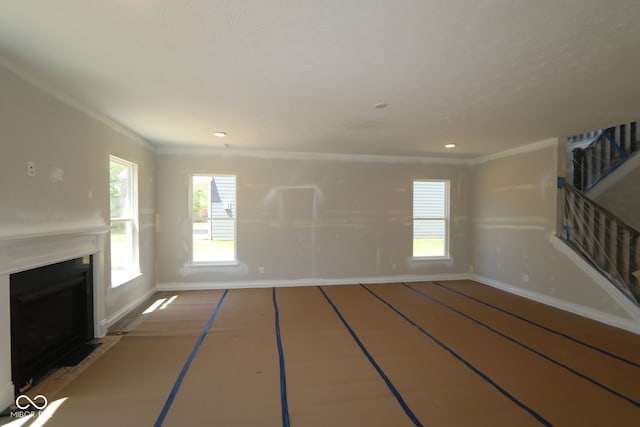5517 Sienna Ct, Brownsburg, IN 46112 - unfurnished living room featuring baseboards, a fireplace with flush hearth, crown molding, and recessed lighting