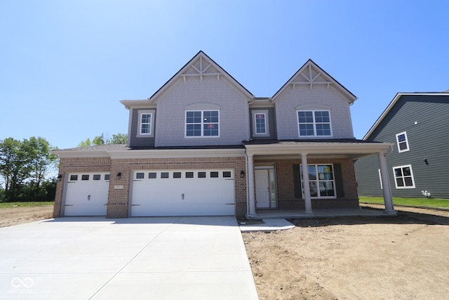 5517 Sienna Ct, Brownsburg, IN 46112 - view of front of home featuring a porch, brick siding, driveway, and a garage
