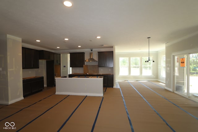 5517 Sienna Ct, Brownsburg, IN 46112 - kitchen with wall chimney exhaust hood, plenty of natural light, recessed lighting, a center island, and baseboards