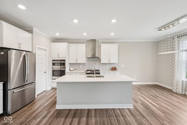 15418 Tattersalls Ln, Fishers, IN 46040 - kitchen with stainless steel appliances, wall chimney exhaust hood, crown molding, an island with sink, and light countertops