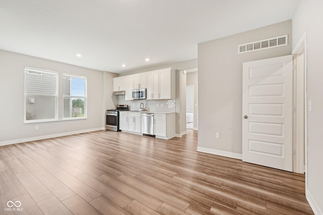 15418 Tattersalls Ln, Fishers, IN 46040 - unfurnished living room featuring light wood finished floors and recessed lighting