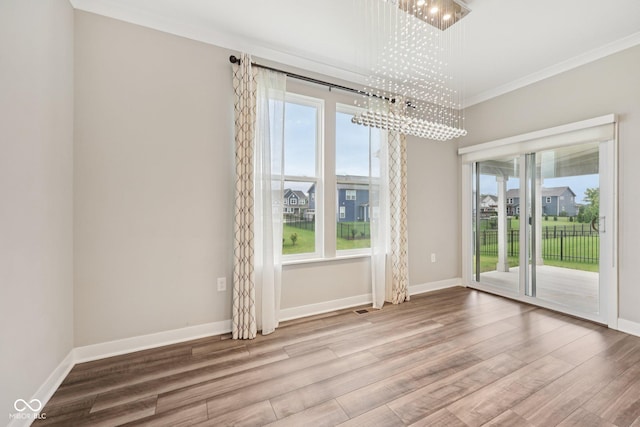 15418 Tattersalls Ln, Fishers, IN 46040 - spare room featuring wood finished floors, ornamental molding, and a chandelier