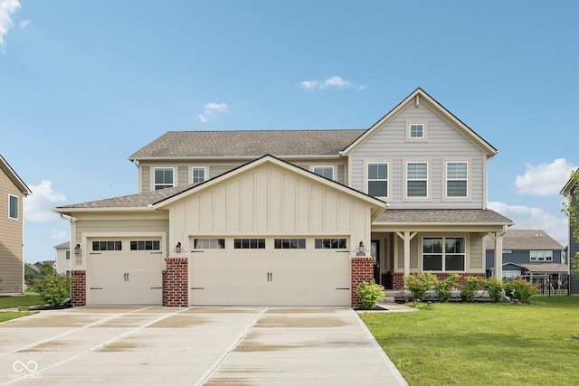 15418 Tattersalls Ln, Fishers, IN 46040 - craftsman house featuring a garage, concrete driveway, a front yard, board and batten siding, and brick siding