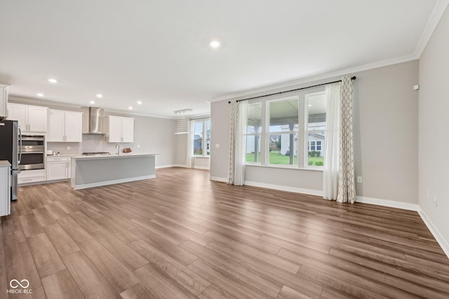 15418 Tattersalls Ln, Fishers, IN 46040 - unfurnished living room with ornamental molding, recessed lighting, and light wood-type flooring