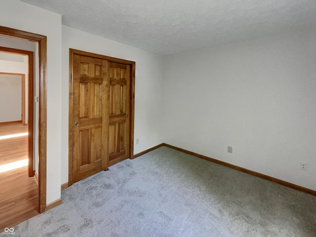 4825 May Ridge Ln, Indianapolis, IN 46254 - unfurnished bedroom with baseboards, carpet, and a textured ceiling