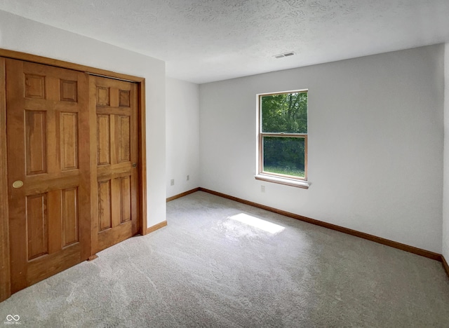 4825 May Ridge Ln, Indianapolis, IN 46254 - unfurnished bedroom featuring carpet floors, baseboards, and a textured ceiling