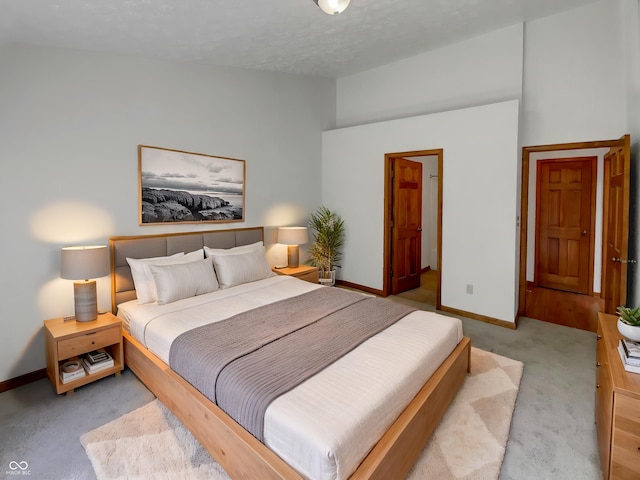 4825 May Ridge Ln, Indianapolis, IN 46254 - bedroom with carpet flooring, vaulted ceiling, baseboards, and a textured ceiling
