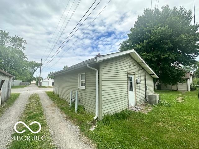 162 N Gladstone Ave, Columbus, IN 47201 - view of home's exterior featuring central AC, driveway, and a lawn