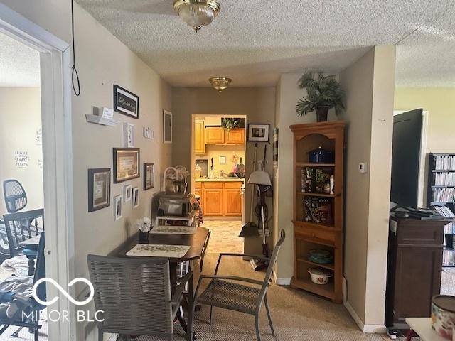 162 N Gladstone Ave, Columbus, IN 47201 - dining area with a textured ceiling, light colored carpet, and baseboards