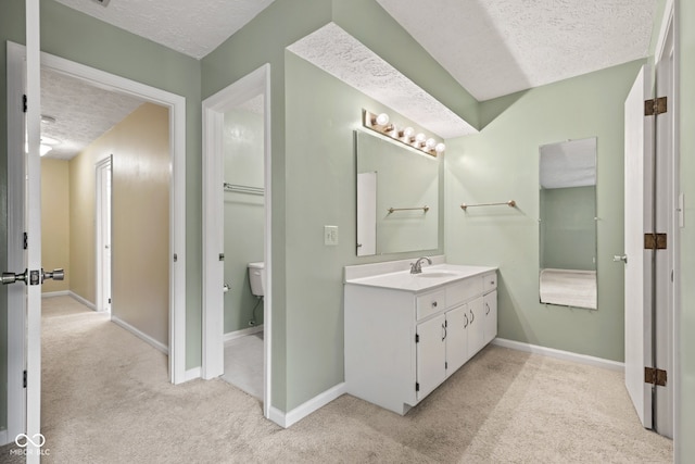 8934 Pinyon Ct, Indianapolis, IN 46260 - bathroom featuring a textured ceiling, vanity, carpet flooring, toilet, and baseboards