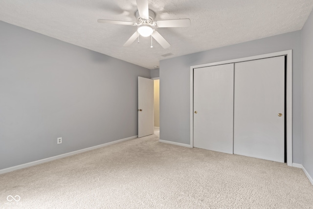 8934 Pinyon Ct, Indianapolis, IN 46260 - unfurnished bedroom with carpet flooring, a closet, a textured ceiling, baseboards, and a ceiling fan