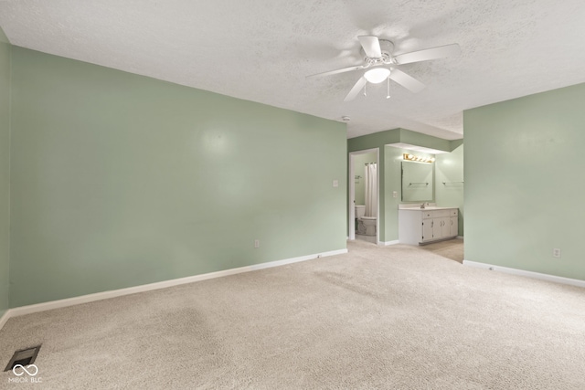 8934 Pinyon Ct, Indianapolis, IN 46260 - unfurnished bedroom with a textured ceiling, light colored carpet, ensuite bath, baseboards, and ceiling fan