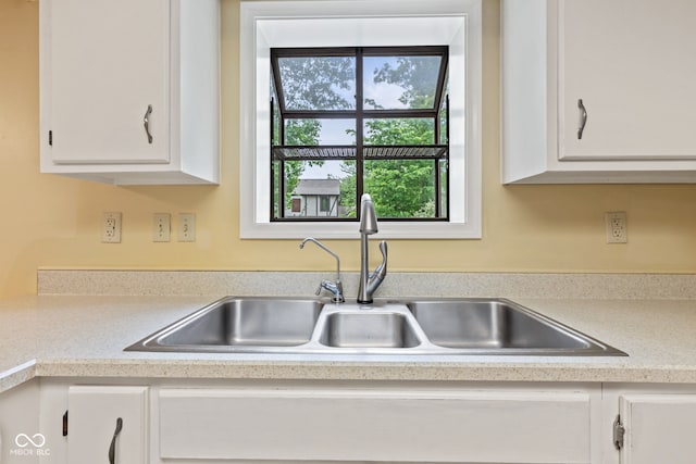 8934 Pinyon Ct, Indianapolis, IN 46260 - kitchen featuring a sink, light countertops, and white cabinets