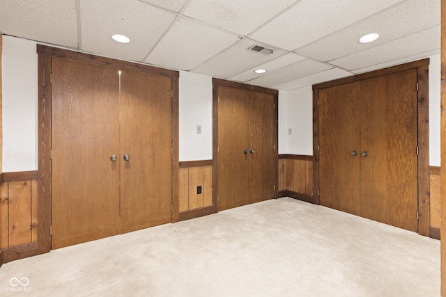 8934 Pinyon Ct, Indianapolis, IN 46260 - unfurnished bedroom with a paneled ceiling, a wainscoted wall, carpet floors, wooden walls, and a closet