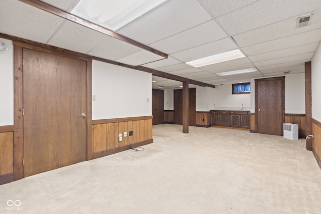 8934 Pinyon Ct, Indianapolis, IN 46260 - finished basement with a paneled ceiling, wooden walls, a wainscoted wall, and carpet