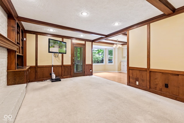 8934 Pinyon Ct, Indianapolis, IN 46260 - unfurnished living room featuring carpet floors, beam ceiling, a textured ceiling, a chandelier, and wainscoting