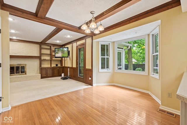 8934 Pinyon Ct, Indianapolis, IN 46260 - unfurnished living room with hardwood / wood-style flooring, a fireplace, a chandelier, beam ceiling, and baseboards