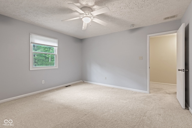 8934 Pinyon Ct, Indianapolis, IN 46260 - empty room with light colored carpet, a ceiling fan, baseboards, and a textured ceiling