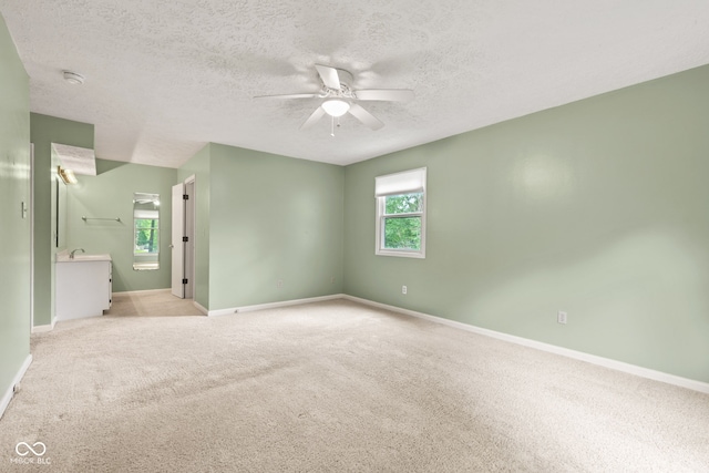 8934 Pinyon Ct, Indianapolis, IN 46260 - unfurnished room featuring ceiling fan, baseboards, light carpet, and a textured ceiling