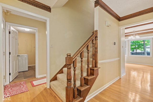 8934 Pinyon Ct, Indianapolis, IN 46260 - staircase featuring hardwood / wood-style floors, baseboards, a chandelier, and ornamental molding