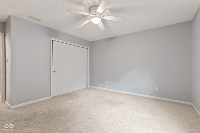 8934 Pinyon Ct, Indianapolis, IN 46260 - unfurnished bedroom with carpet flooring, a textured ceiling, a closet, baseboards, and ceiling fan
