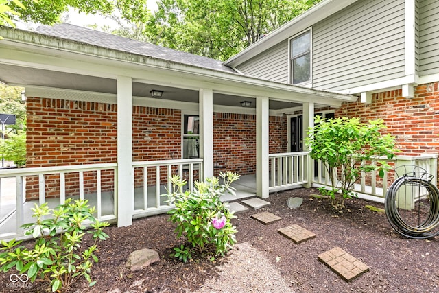 8934 Pinyon Ct, Indianapolis, IN 46260 - property entrance featuring brick siding and a porch