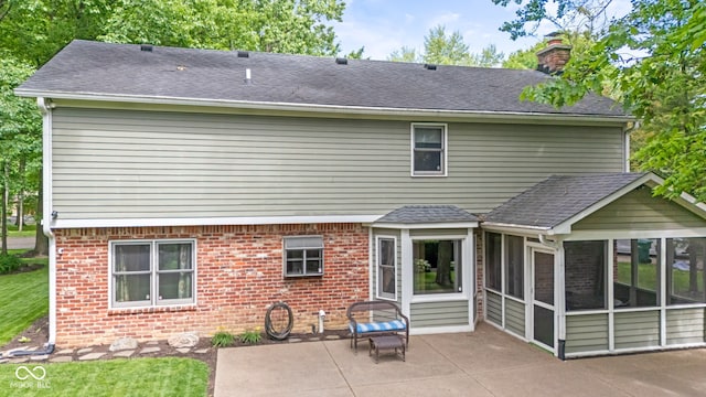 8934 Pinyon Ct, Indianapolis, IN 46260 - back of house with a sunroom, a chimney, a patio, and roof with shingles