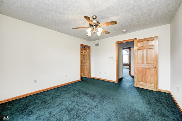 7333 State Road 42, Martinsville, IN 46151 - spare room featuring a ceiling fan, baseboards, dark colored carpet, and a textured ceiling