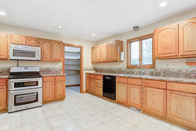 7333 State Road 42, Martinsville, IN 46151 - kitchen with range with two ovens, dishwasher, a sink, recessed lighting, and a textured ceiling