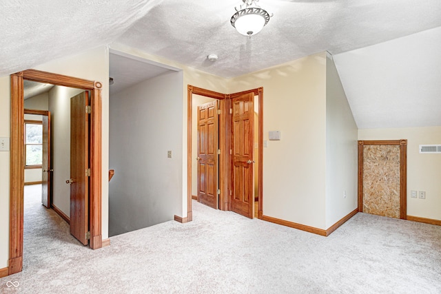 7333 State Road 42, Martinsville, IN 46151 - corridor with lofted ceiling, carpet floors, a textured ceiling, baseboards, and an upstairs landing