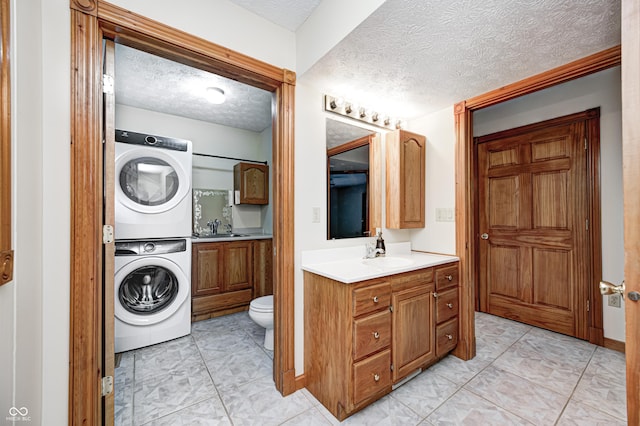 7333 State Road 42, Martinsville, IN 46151 - full bath with stacked washer / dryer, a textured ceiling, toilet, and vanity