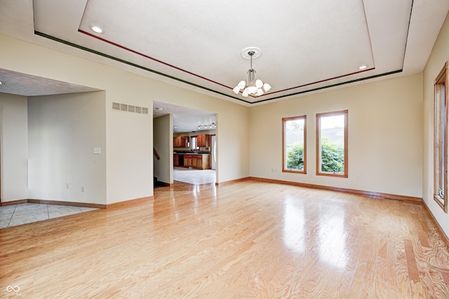 7333 State Road 42, Martinsville, IN 46151 - unfurnished living room featuring a chandelier, wood finished floors, recessed lighting, baseboards, and a raised ceiling