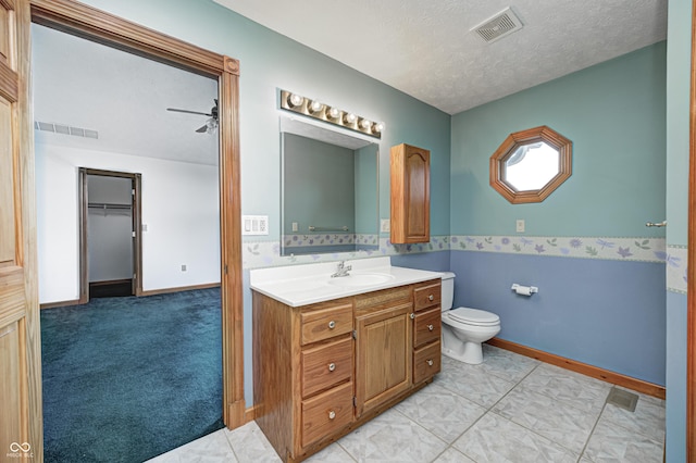 7333 State Road 42, Martinsville, IN 46151 - bathroom with vanity, toilet, a textured ceiling, baseboards, and a ceiling fan