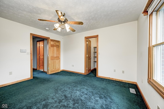 7333 State Road 42, Martinsville, IN 46151 - empty room featuring dark carpet, baseboards, a ceiling fan, and a textured ceiling