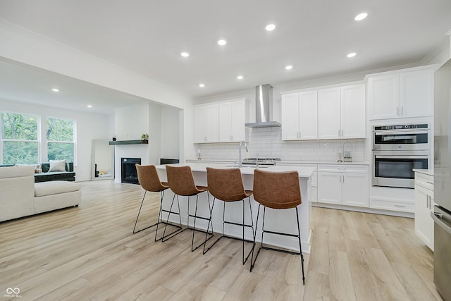 1510 Stonehaven Dr, Westfield, IN 46074 - kitchen featuring wall chimney range hood, double oven, light countertops, backsplash, and recessed lighting